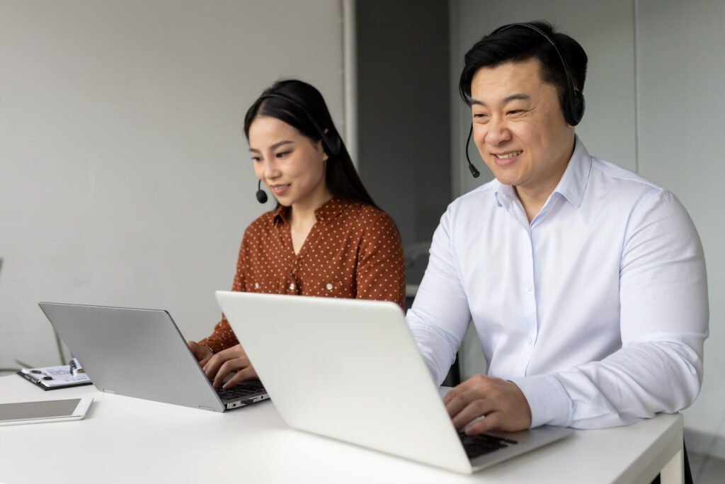 asian business professionals working with laptops q6g5377